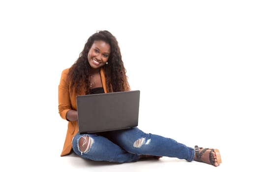 Young african student working with her laptop, isolated over a white background
