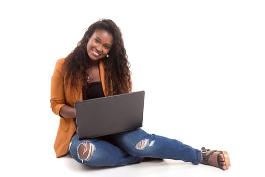 Young african student working with her laptop, isolated over a white background