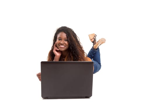 Young african student working with her laptop, isolated over a white background