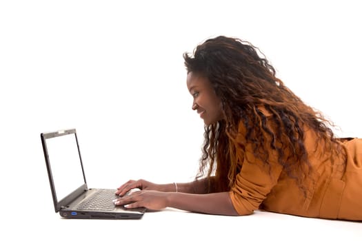 Young african student working with her laptop, isolated over a white background