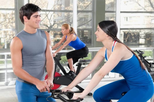 Three people working out in a gym