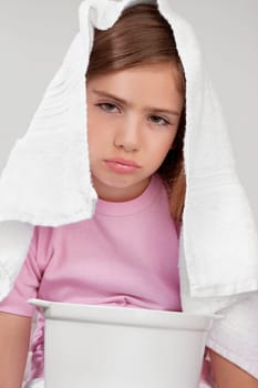 Portrait of a girl inhaling steam