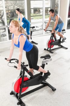 Three people working out in a gym