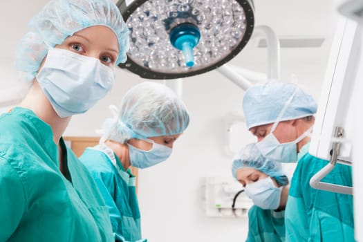 Surgeons performing a surgery in an operating room
