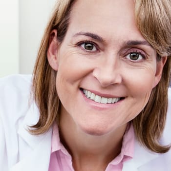 Portrait of a female scientist smiling in a laboratory