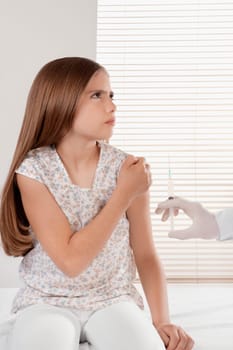 Doctor giving an injecting to a girl