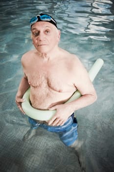 Man using a pool float in a swimming pool