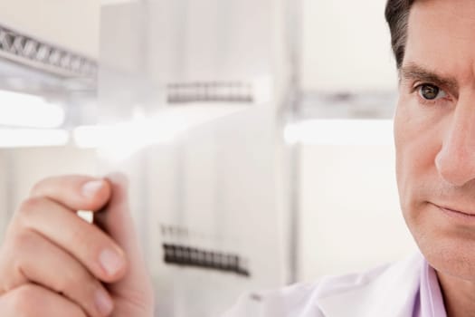 Scientist examining a report in a laboratory