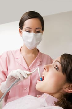 Dentist cleaning womanŽs teeth