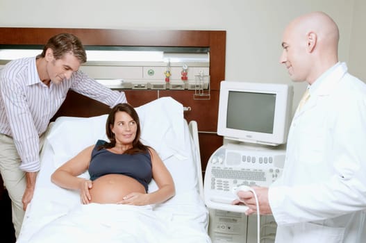 Pregnant woman in a hospital with her husband