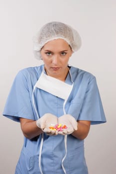 Female nurse holding pills