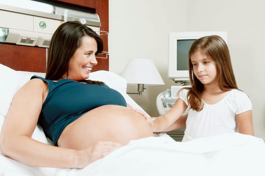 Pregnant woman in a hospital with her daughter