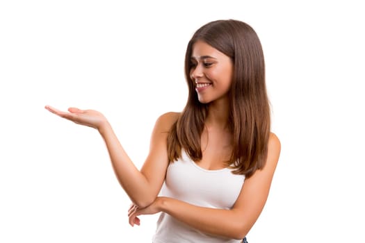 Young beautiful woman presenting your product, isolated over white background