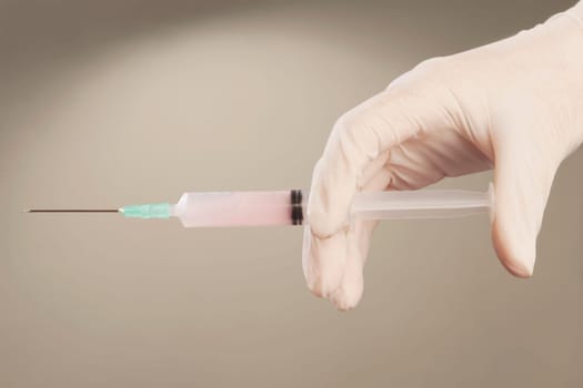 DoctorŽs hand holding an injection