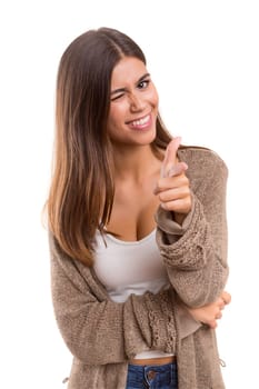 Young beautiful woman pointing at you, isolated over white