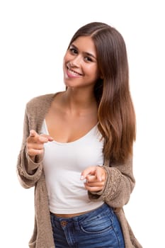 Young beautiful woman pointing at you, isolated over white