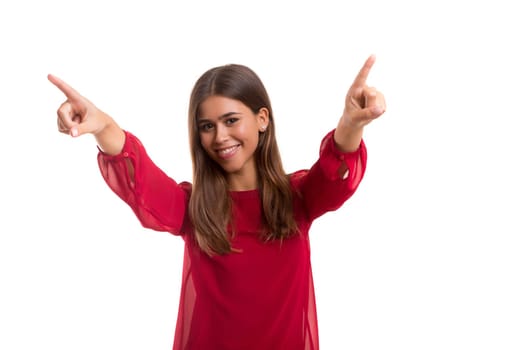 Young beautiful woman pointing at you, isolated over white