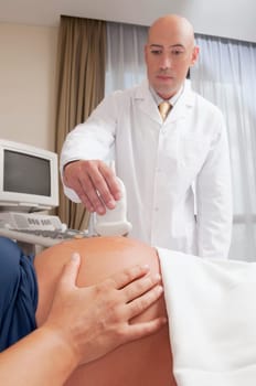 Pregnant woman going through an ultrasound scan