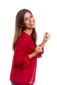 Studio shot: Happy woman with raised arms