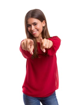 Young beautiful woman pointing at you, isolated over white