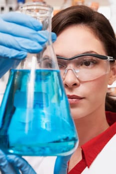 Female doctor holding a conical flask in a laboratory