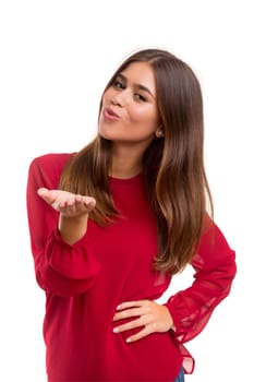 Beautiful young woman blowing you a kiss, isolated over white
