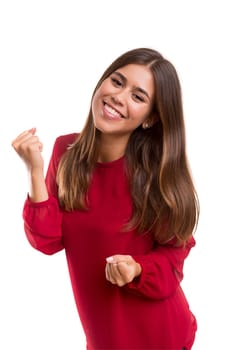 Studio shot: Happy woman with raised arms