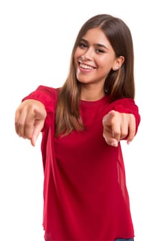 Young beautiful woman pointing at you, isolated over white