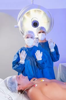 Two surgeons with a patient in an operating room