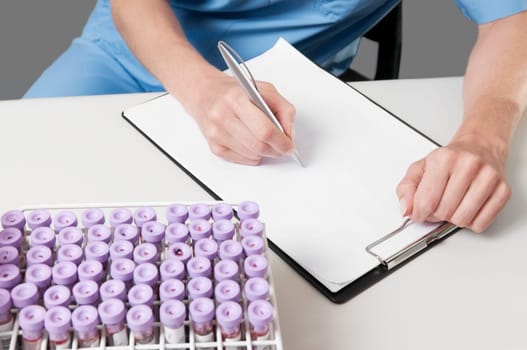 Female lab technician preparing a medical report