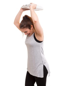 Diet concept - Mad woman destroying her scale