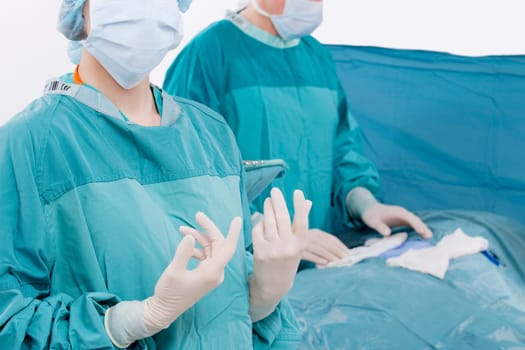 Two surgeons performing a surgery in an operating room