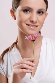 Portrait of a woman smelling a flower