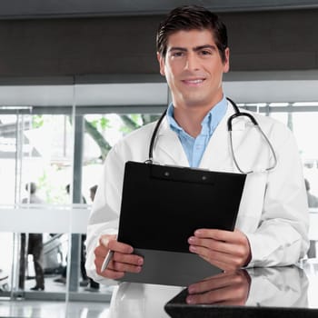 Portrait of a doctor holding a clipboard
