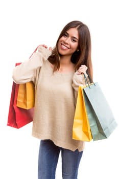 Young beautiful woman with shopping bags, isolated over copy space background