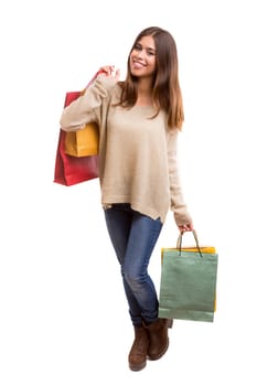 Young beautiful woman with shopping bags, isolated over copy space background