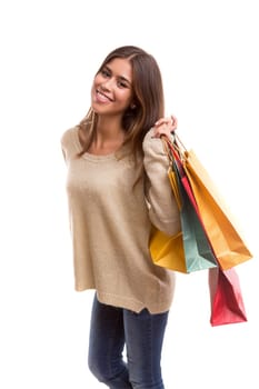 Young beautiful woman with shopping bags, isolated over copy space background