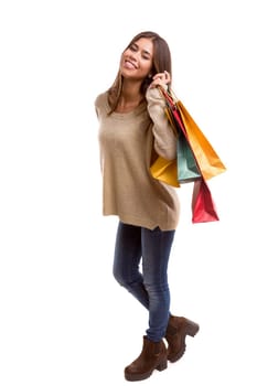 Young beautiful woman with shopping bags, isolated over copy space background