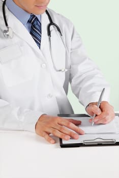 Doctor writing on a clipboard
