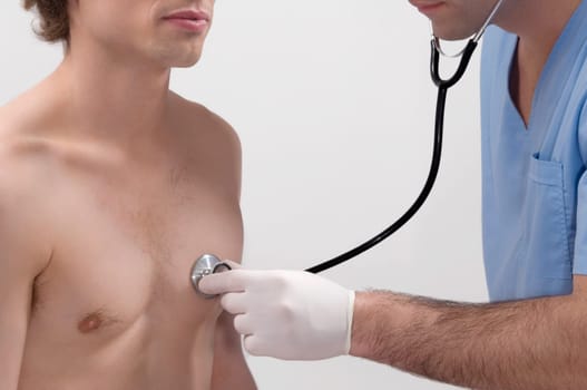 Male doctor examining a patient with a stethoscope