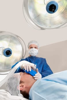 Doctor anaesthetizing a patient in an operating room