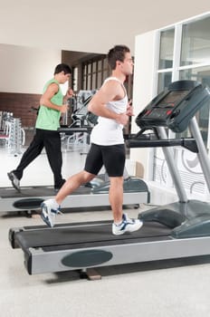 Two men running on treadmills