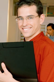 Close_up of a male doctor holding a file
