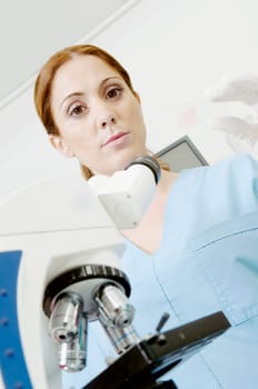 Female lab technician analyzing a sample in a laboratory