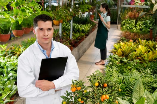 Scientist holding a clipboard in a greenhouse