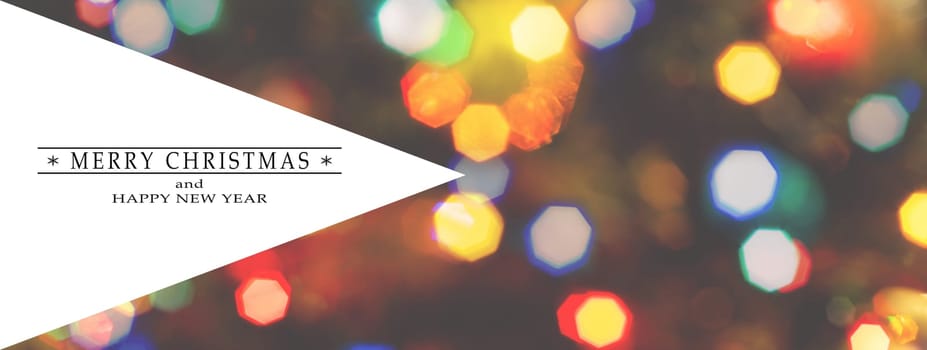 Merry Christmas and Happy New Year greeting card, blurred background of the twinkling lights of the Christmas tree. Greeting card background. Text space