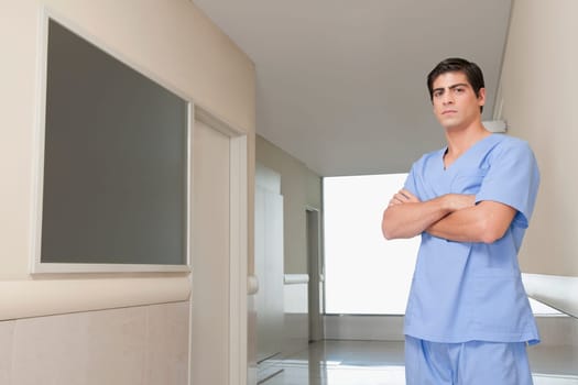 Surgeon standing in the corridor of a hospital