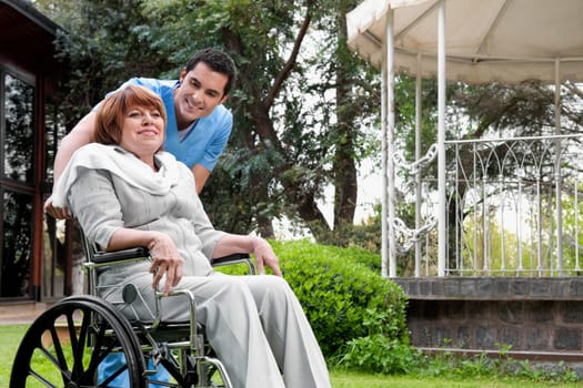 Healthcare worker pushing a woman sitting in a wheelchair