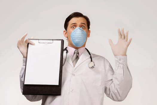 Doctor wearing a flu mask and showing a clipboard