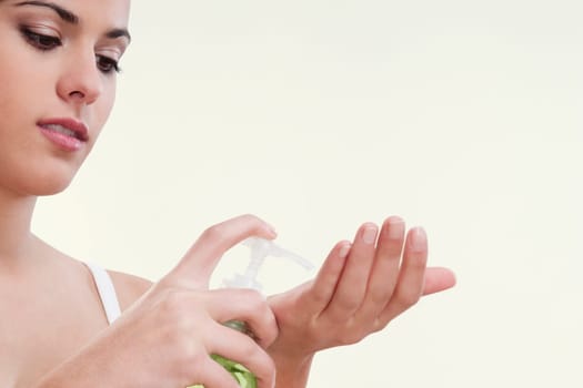 Woman using a soap dispenser